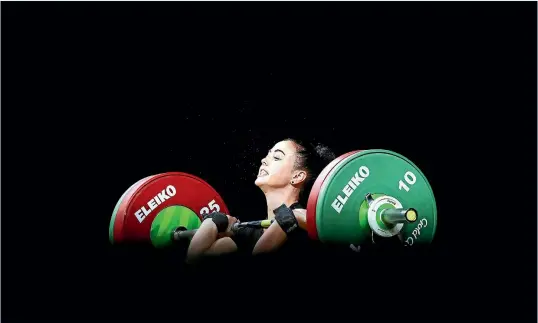  ?? PHOTOSPORT/GETTY IMAGES ?? New Zealand weightlift­er Pip Patterson competes in the women’s 53kg final on the Gold Coast yesterday. She finished sixth.