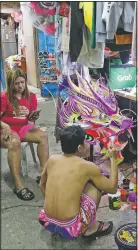  ??  ?? Robert Sicat paints a dragon head as members of a Dragon and Lion Dance Group seek other ways to earn a living.