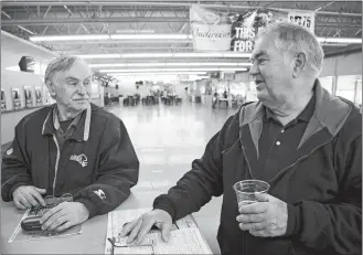  ?? NATI HARNIK/AP PHOTO ?? Ron Tenski and Jerry Moritz, right, who had arrived to Fonner Park in Grand Island, Neb., for the horse races on Saturday, prepare to leave after the races were called off due to dangerous track conditions following snowfall.