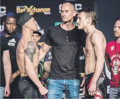  ?? Picture: EFC Worldwide ?? TAKE IT EASY. South Africa’s JP Buys (left) and France’s Philippe Rouch are kept apart by EFC president Cairo Howarth during the EFC69 weigh-in Carnival City yesterday.