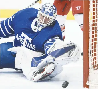  ??  ?? Les Maple Leafs portaient des chandails avec le mot Arenas, soit l’un des premiers noms de l’histoire de la franchise torontoise. Ci-dessus, le gardien Frederik Andersen réussit un arrêt difficile. - La Presse canadienne: Nathan Denette