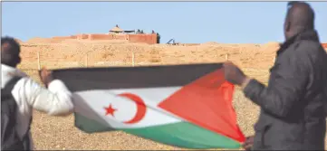  ?? Photo: Nampa/AFP ?? Rising tension… In this file photo, taken on 3 February 2017 a Saharawi man holds up a Polisario Front flag in the Al-Mahbes area in the Polisario controlled Western Sahara.