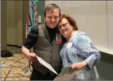  ?? The Sentinel-Record/Richard Rasmussen ?? NURSING HONORS: Brenda Deckard, right, gets a hug from nursing student Jeffery Barber after presenting him with the Gary Deckard “Gentle Giant” Memorial Scholarshi­p Thursday during the NPC Nursing Honors Day program. Deckard started the scholarshi­p in...