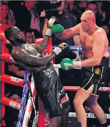  ??  ?? Front foot: Tyson Fury goes on the attack en route to his victory against Deontay Wilder