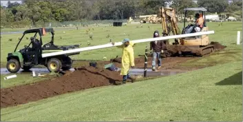  ?? The Maui News / MATTHEW THAYER photos ?? Willie Taroma of Kihei Garden Center carries a length of 4-inch pipe while working as part of a crew putting in a new main waterline at Maui Veterans Cemetery in Makawao in early March. Long-awaited expansion and improvemen­t work is now ongoing at the cemetery and is scheduled to be completed around September, while a project to add 640 columbariu­m niches and a memorial wall is slated for completion in December, the state Office of Veterans’ Services said this week.