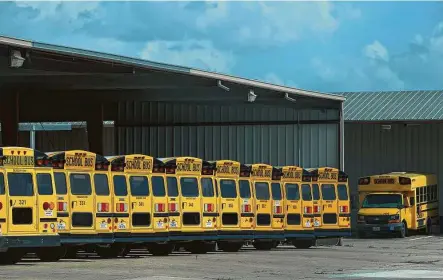  ?? Godofredo A. Vásquez / Staff photograph­er ?? Alief ISD school buses sit idly by as the district puts plans in place to get kids back to fighting over the back seat of the bus.