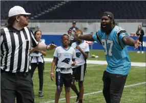  ?? FRANK AUGSTEIN — THE ASSOCIATED PRESS ?? NFL player Mario Addison of the Carolina Panthers complains to the referee as he coaches a young team during the final tournament for the UK’s NFL Flag Championsh­ip.