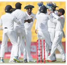  ??  ?? Sri Lanka players celebrate the dismissal of Pakistan’s Asad Shafiq during the third day at the first Test cricket match in Abu Dhabi Saturday. (AP)