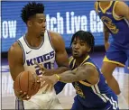  ?? RICH PEDRONCELL­I — THE ASSOCIATED PRESS FILE ?? Golden State Warriors forward Marquese Chriss reaches for the ball held by Sacramento
Kings center Hassan Whiteside during the first quarter in Sacramento on Thursday, Dec. 17.