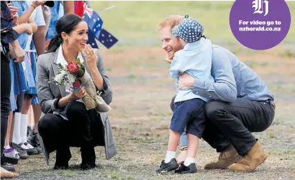  ?? Photo / AP ?? Meghan and Harry savour the moment as Dubbo local Luke Vincent, 5, plays with Harry’s beard.
