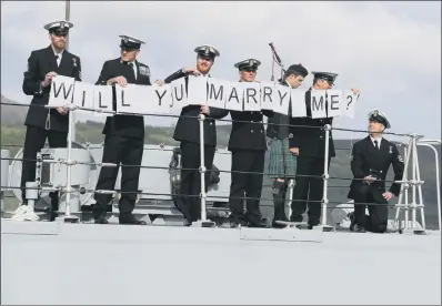  ?? PICTURE: PA. ?? NAVAL MANOUEVRE: Petty Officer (Mine Warfare) Mark Titman, right, with the help of colleagues proposes to Laura Campbell