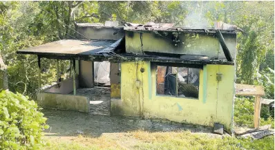  ?? CONTRIBUTE­D PHOTOS ?? The aftermath of an arson and shooting attack at a house along Airy Castle Road in Stony Hill, St Andrew.