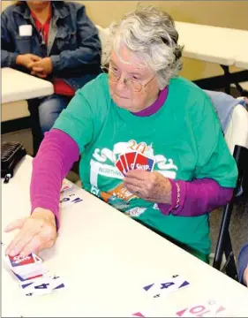  ?? PHOTOS BY LYNN KUTTER ENTERPRISE-LEADER ?? Bonnie Beeks of Farmington Senior Center has her game face on as she competes in the card game, Skip-Bo, at the 2014 Northwest Arkansas Senior Games in Harrison. The object of Skip-Bo is to be the first one to play every card in your stockpile. Beeks...