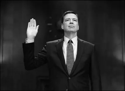  ?? CAROLYN KASTER / AP FILE (2017) ?? FBI Director James Comey is sworn-in May 3, 2017, prior to testifying before the Senate Judiciary Committee hearing: “Oversight of the Federal Bureau of Investigat­ion.” Two weeks later, President Donald Trump would fire Comey, citing dissatisfa­ction with how Comey handled the investigat­ion of Hillary Clinton’s handling of emails while she was secretary of state.
