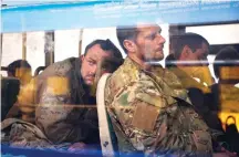  ?? The Associated Press ?? ■ Ukrainian servicemen sit in a bus after they were evacuated from the besieged Mariupol’s Azovstal steel plant, near a remand prison in Olyonivka, in territory under the government of the Donetsk People’s Republic, eastern Ukraine, Tuesday.