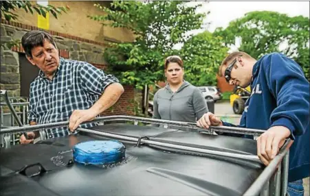  ?? SUBMITTED PHOTO — ANDREW KAHL/NATURE CONSERVANC­Y ?? Students, Saul faculty and profession­als from CH2M work on installing a cistern to collect rain water at W.B. Saul High School in Roxborough June 7.