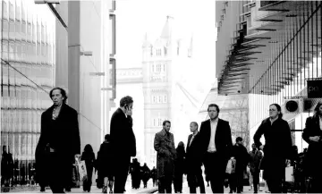  ??  ?? Office workers are seen in the London Place business district near Tower Bridge in central London. If Britain leaves the European Union on March 29 without a withdrawal deal, all bets are off on what will happen to the just-in-time production system on which the European auto industry relies, or to demand for vehicles across the continent. — Reuters photo