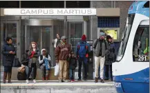  ?? CARLOS OSORIO / ASSOCIATED PRESS ?? Passengers wait last month for the QLINE transit train in Detroit. Cities such as Detroit are touting their population­s of minority residents as companies seek diversity.