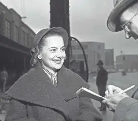  ?? JOURNAL SENTINEL FILES ?? Olivia de Havilland talks with a reporter at the Milwaukee Road Depot train station in Milwaukee Oct. 22, 1951. The two-time Oscar-winning actress was in town to appear in “Candida” at the Davidson Theatre. This photo was published in the Oct. 22, 1951, Milwaukee Journal.