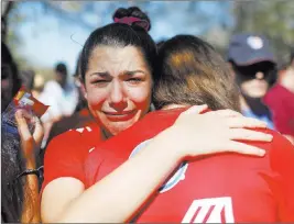  ?? Brynn Anderson ?? The Associated Press A student mourns the loss of her friend during a vigil Thursday at Pine Trails Park in Parkland, Fla., for the victims of the Marjory Stoneman Douglas High School shooting.