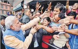  ?? PTI ?? PM Narendra Modi got down from his car to greet people lined up along a road in Kathmandu on Sunday.