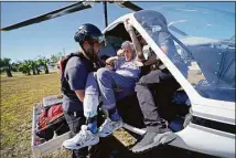  ?? Gerald Herbert / Associated Press ?? Members of mediccorps.org help evacuate Tom Acerbo in the aftermath of Hurricane Ian on Pine Island, Fla., on Oct. 1. Older people with limited mobility and those with chronic health conditions were especially vulnerable when Hurricane Ian slammed into Southwest Florida.