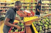  ?? /Reuters ?? Local is better: Workers pack out vegetables at a Harare store. Zimbabwe has halted fruit and vegetable imports.