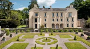  ??  ?? The mansion house at Aberglasne­y, with its manicured Cloister Garden. It is bounded by a three-sided arcaded walkway.