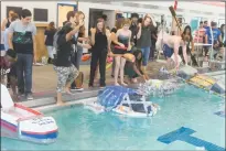  ?? STAFF PHOTOS BY JAMIE ANFENSON-COMEAU ?? Student teams at Henry Lackey High School prepare to launch their boats in the school swimming pool. The school held a recycled boat race Monday.