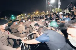  ?? SAKCHAI LALIT/AP ?? Pro-democracy protesters pull steel barricades in front of police as they try to march forward during a demonstrat­ion Saturday in Bangkok.