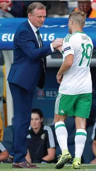  ??  ?? In demand: Michael O’Neill shakes the hand of Jamie Ward as he is substitute­d in Paris