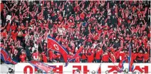  ?? AFP-Yonhap ?? North Korean fans cheer during the final qualifier for the Paris Olympic women’s football at the National Stadium in Tokyo, Wednesday.