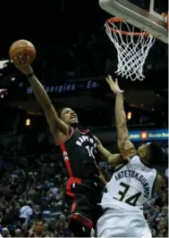  ?? DYLAN BUELL/GETTY IMAGES ?? Toronto’s DeMar DeRozan drives to the basket in Game Six last night in Milwaukee. The Raptors beat the Bucks 92-89.