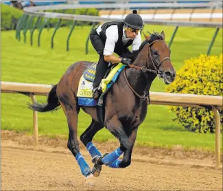  ?? Charlie Riedel The Associated Press ?? Game Winner, one of Bob Baffert’s three entrants for Saturday’s Kentucky Derby, goes through a workout Wednesday at Churchill Downs in Louisville, Ky.