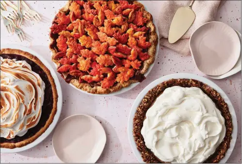  ?? (Mark Weinberg for The Washington Post) ?? From left: Roasted Cranberry with Meringue topping in Press in Cookie Crust; Caramel Apple Pie With an All-Butter Crust and Painted Cutout Topping; Fall-Spice Pudding Pie With Whipped Cream and a Nut Crust.