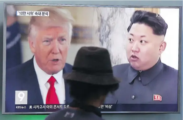  ?? — AP ?? A man watches a news program showing U.S. President Donald Trump and North Korean leader Kim Jong Un in Seoul, South Korea, on Thursday. Trump told reporters Thursday his warning to Kim of ‘fire and fury’ this week may not have been ‘tough enough.’