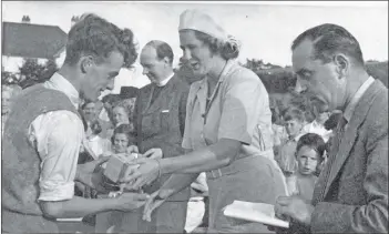  ??  ?? Lady Jean presents a five-a-side football award to Willie Innes of Brodick FC.