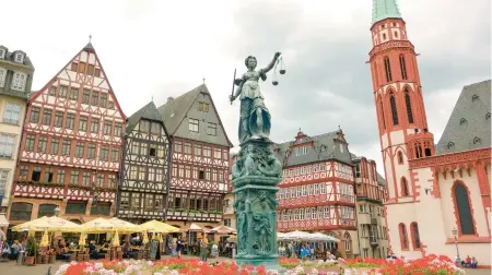  ?? RICK STEVES ?? In Frankfurt’s Romerberg Square, the half-timbered buildings were rebuilt in 1983, after bombs destroyed the originals during World War II.