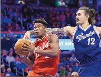  ?? ALONZO ADAMS/THE ASSOCIATED PRESS ?? Chicago guard Jimmy Butler, left, drives to the basket while Oklahoma City’s Steven Adams (12) tries to defend. Butler scored 23 points and Chicago won 105-96.