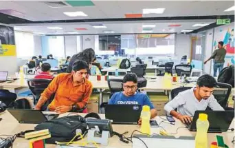  ?? Bloomberg ?? Employees work on laptops at the Flipkart Online Services headquarte­rs in Bengaluru, India. The total value of the company is around $20 billion.