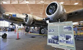  ?? TY GREENLEES / STAFF ?? The iconic Memphis Belle is being restored at the National Museum of the U. S. Air Force for a May 2018 display debut. The B-17’s tail gunner’s turret was bolted back on Wednesday.