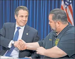  ??  ?? Shake on it: In 2014, Gov. Cuomo and the MTA’s major union boss, John Samuelsen, reached an agreement that delivered little by way of reform.