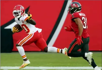  ?? AP Photo/Mark LoMoglio ?? In this 2020 file photo, Kansas City Chiefs wide receiver Tyreek Hill (10) reacts as he beats Tampa Bay Buccaneers strong safety Antoine Winfield Jr. (31) on a 75-yard touchdown reception during the first half of an NFL football game in Tampa, Fla.