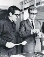  ?? ?? g Hot stuff: Deighton tries to teach Michael Caine how to crack eggs for the 1965 film of The Ipcress File ‘The Ipcress File’ starts on ITV tomorrow at 9pm