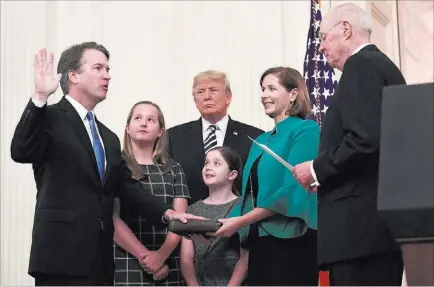  ?? Susan Walsh ?? The Associated Press Retired Supreme Court Justice Anthony Kennedy, right, ceremonial­ly swears in Supreme Court Justice Brett Kavanaugh on Monday at the White House, alongside Kavanaugh’s wife Ashley, daughters Margaret, second from left, and Liza, and President Donald Trump.