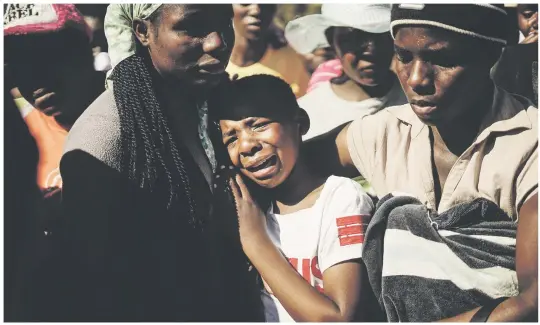  ?? Picture: AFP ?? GRIEF. Ahlia Kumire, centre, daughter of Ishmael Kumire, 42, during her father’s funeral after he was shot during post-election violence at his homestead in Chinamhora village, Domboshava, outside Harare. Kumire was shot dead while standing at his...