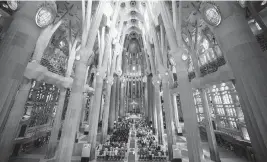  ?? EMILIO MORENATTI AP ?? Worshipper­s attend a Mass in the Sagrada Familia basilica in Barcelona on July 9. With tourism reaching pre-pandemic levels across Europe, iconic sacred sites struggle to accommodat­e the faithful who come to pray and visitors attracted by art and architectu­re.