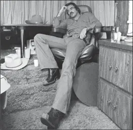  ?? The Associated Press ?? SMOKEY DRIVE: Burt Reynolds sits in his trailer on the set of “Smokey and the Bandit,” in Atlanta on Sept. 23, 1976. Hundreds of fans in Trans Ams made it to Atlanta to celebrate the 40th anniversar­y of “Smokey and the Bandit.” About 350 cars retraced actor Burt Reynolds’ wild ride from the Texas-Arkansas line to Atlanta in the movie that roared into pop culture in 1977.