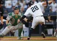  ?? ?? A's catcher Sean Murphy tags out New York Yankees' Josh Donaldson during the first inning on Tuesday in New York.