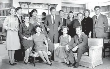  ?? Associated Press ?? JOHN F. KENNEDY, center, then president-elect, is surrounded in 1960 by various members of his family, including his wife, parents and siblings, at father Joseph P. Kennedy’s home in Hyannispor­t, Mass.